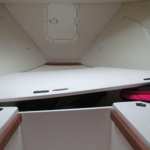 the anchor locker is the vertical hatch straight ahead in the middle.The whole front horizantal lid left ajar for this picture and can be completely removed to access storage area