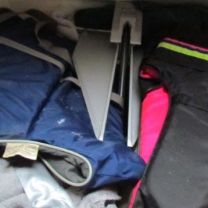 extra prop, complete extra set of ground tackle with anchor 20' of chain with 200' of rode, couple extra life jackets to keep things from rattling around all in the larger front bow compartment