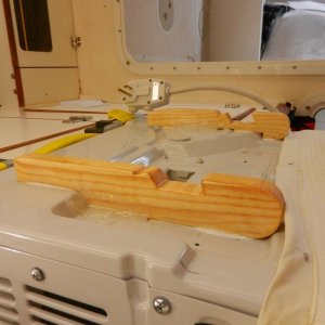 The first thing I did was epoxy some "feet" on the bottom of the AC.  There are "hooks" cut into the feet to sit on the window frame.  These are glued down with 5200.