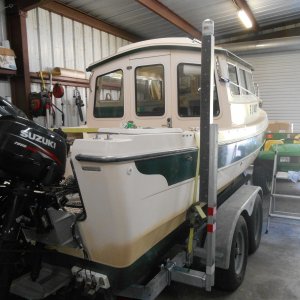 Heavy duty vertical guides.  These won't bend.  Wind, waves, current no problem.  Steer the bow between these guides, steer the stern around, and power up to the winch.  They solved my loading problems.