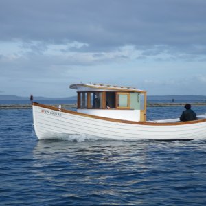 I believe this is an outboard powered vessel, OB in the stern well.  Nice lines, no wake and very clean.  Wooden boat, Port Townsend, WA.