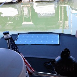 Mounting a 100w solar panel on your bimini as shown will give you full sun access and will allow you to fold bimini against bulkhead for fishing.  It can also be easily removed if desired if mounted correctly