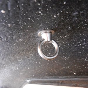 A 1/2" SS carriage bolt, e.g., http://www.mcmaster.com/#93180a208/=pbow9t and a matching eye nut, e.g., http://www.reddenmarine.com/sea-dog-078106-stainless-steel-eye-nut-1-  4.html were used.  I cut a square hole in the fiberglass to match the carriage bolt shoulder.