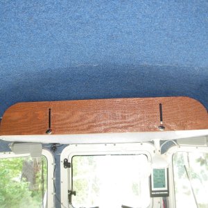 Overhead storage in closed position.  Wing nuts alow it to be locked in place.
Most of inside of boat is covered w/ headliner/ indoor/ outdoor carpet which serves two purposes:  Insulation and condensensation prevention, and something velcro "hooks" will cling to.
