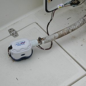 Media 'New bilge pump wired and plumbed, ready to drop back down the hole and secure to hull.' in album '1" cores cut from transom. Closed cell foam core. Garboard flanges and plugs. Orange plugs are emergency spares.'
