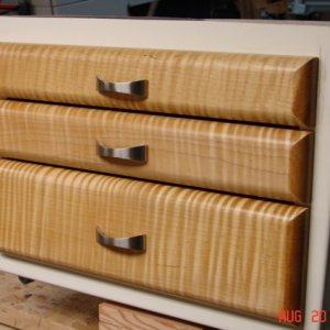 Media 'Finished drawer fronts.  Curly maple with 2 coats dark garnet shellac then 2 coats satin poly.  SS pulls from Lee Valley.' in album 'Front passenger seat base cut out for drawers'