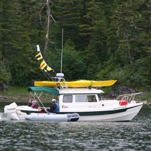 The Commodore's boat, Bidarka with signal flags flying