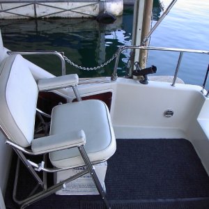 Starboard side of cockpit and chair Locking dark plexiglass compartments house pressure water intake, pumpout fittings.