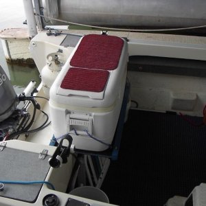 This cooler has a very convenient small door in the side of the top so you don't have to open the whole top, moving everything and letting heat in.