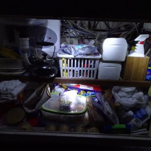 under sink, shows the 2.5 gallon Bosch water heater behind the sink. Also note secondary electrical fuse and distribution system