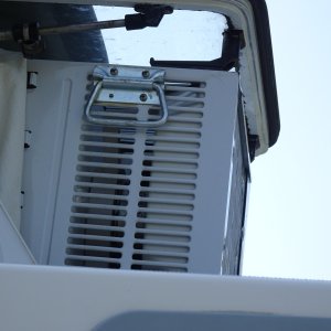 Window air condition 5000 'BTU, note handles for hoisting from inside.  There is a block and tackle system which uses the same spreader bar that is used for the dinghy and hooks onto these handles, making putting the AC unit into the window a one person activity.