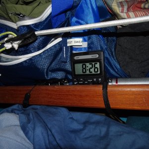 clock and flashlights on shelf by bunk