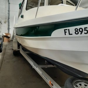 Media 'Home in Winter storage Wilson, NY.  My marina guys did an awesome job restoring gel coat and forest green stripe.' in album '12/28/20 Pick day central Florida'