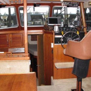 Captains chair on electric shaft so it can be lowered to the same level as the salon seating.