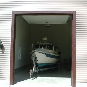 Door is 10ft wide and 12 Ft tall.  Overall, the Garage is 18 Ft wide and 34ft long inside.  Plenty of room for Captain's Choice and Kubota Tractor!