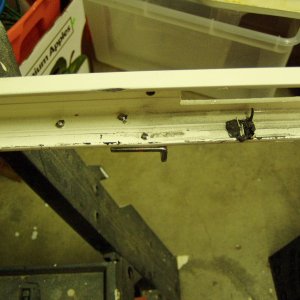 I think the two screws used to install the door holder may have caused the window to shatter.  I ground them down so they would not contact the edge of the new window.