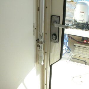Media 'Plenty of clearence between boat hook and door handle when door is closed. Aft deck hatch is open to air out bildge after cleaning pump strainer.' in album 'Third (3rd) fire extinguisher added inside cabin, port side.'