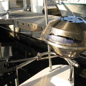If you rip the rail mount off the bar mount of a magma grill it slips nicely into a scotty downrigger mount for full 360 push button rotation and still removes with no tools.