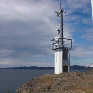 Automated light house, Turn Point, Stuart Island.  In the back ground is South Pender Island, Canada.