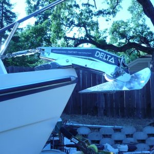 Close Fit. New Delta 14 Fast set just clears (old Bruce 11 had plenty of room)as the auto launch drops. Note second shackle at top of anchor allows simple clip to top of roller bar for trailering security. Stainless shackle and SS swivel also just fit in front of windlass even at full tension. Shackle\swivel combo eliminates most of the possibility of side loading on the swivel (I think).