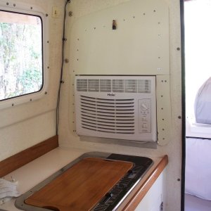 Original window was removed and could be reinstalled at any time. No screw holes were placed in either the enterior or exterior walls; the screws go into a 3/4in plywood panel cut to fit in the window opening not occupied by the AC to hold the interior panel in place. The exterior panel is glued to that 3/4in plywood and thus the interior and exterior panels are pulled together by tightening the screws.