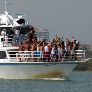 Spring break crowd dancing on the bow