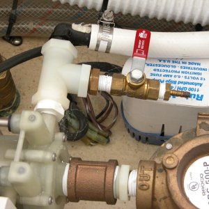 A closer look at Sea Angel's air conditioner water pump bleeder valve with its red handle closed. The circulation pump needs to be primed to work. It does not have to have power to be primed, if in the water. It is below the water line. Just open the bleeder valve to prime, then close to operate the A/C.