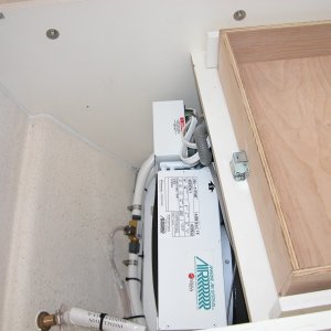 AC is located under mate's seat. The "T" in the cooling line is to drain the drip pan of any condensation buildup.