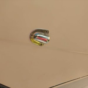 Gemlux clamshell cover covering the anchor locker drain hole.