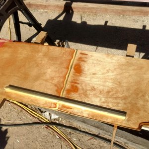 I made a cover to fill the opening to the anchor locker in hopes of keeping water off the V-berth cushions when hauling in the rode/chain with the windlass.

The cleat on the back hangs over the existing fiberglass bulkhead that forms the locker. With 2 coats of epoxy covering the back water "should" just shed right off into the bottom of the locker.