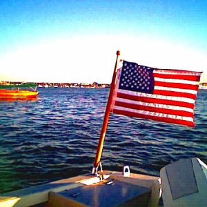 Ensign proudly flying on starboard stern.