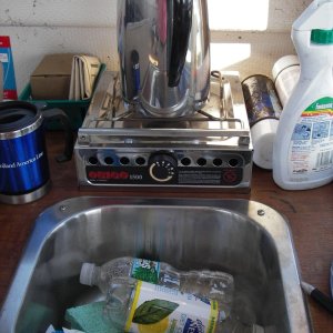 Media 'Shot of galley showing sink and stove behind it. Storage under stove.' in album 'Helm with GPS, Compass, and depth finder. Very simple'
