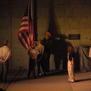 Scouts lowering and folding the flag at Mt. Rushmore evening ceremony.