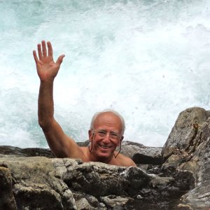 Casey in a warm spring "hole" at Baranof Warm Springs with the raging falls a foot or two away.