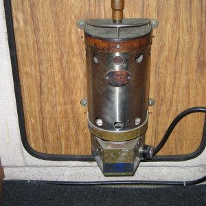 Propane Force 10 heater mounted on inside of door.  Propane hose goes down along water hose, thru cabinet and out into cockpit shelf.