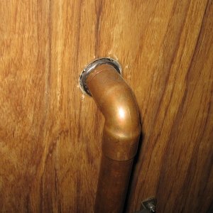 Stack made of copper water pipe and fittings goes thru door.