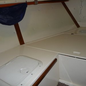 Cutty, Forward to Port.
Wooden boat paddle held up under port forward deck.
Access hatch to storage locker.