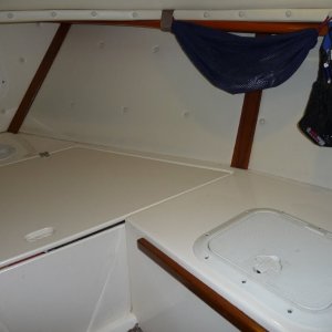 Cutty, forward to starboard.
Wooden boat paddle held up under port forward deck.
Access hatch to storage locker.