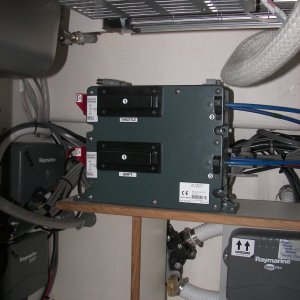 Media 'These are the electric/hydraulic controllers for the Teleflex/Morse fore and aft control stations. They cover the "Y" valve for the head tank macerator discharge. The Wallas stove can be seen at top.' in album 'Okay, it's a "yay-boo" thing where the installer (not C-Dory) put the electronics - under the galley cabinet. Easy access, but you've got to keep large metal things out. I use vinyl tubs for food, etc. here.'
