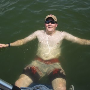 Media 'Son-in-law J enjoying very warm water in PK while sitting on a fender.' in album 'Thanks to our kids in Texas for storing the boat from Florida, awaiting our arrival and towing rest of way to its new home.'