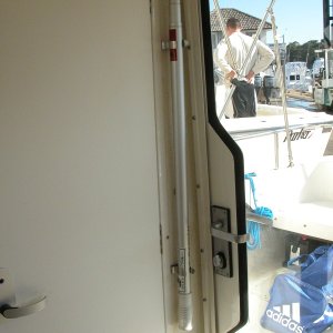 Convient and secure boat hook storeage easily accessibly from cockpit when door is open.