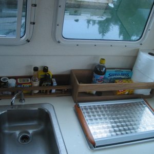 Media '(CheckRaise) A galley storage solution. The teak rail and standalone shelf unit are simply velcroed in.' in album '(CheckRaise) Launch day. The Jeep looks comical, but it performed like a champ.'