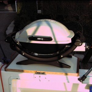Table supports Weber Baby-Q propane gas grill