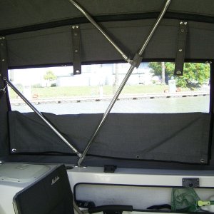 Half screen with the solid panel snapped in the middle. The straps at the top hold the whole side panel when it is rolled up.