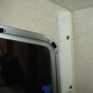 1/2" Seaboard(Tap Plastics)abuts window frame and allows speaker bracket to be scooted over to clear wall. No holes and speakers rotate over 90 degrees
