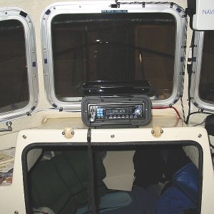 Media 'Enclosure velcroed to acrylic base. $7.00 wire Antenna(SeaWorthy Sea-Ant) bundled with speaker wires to port. Stereo is full-featured but cheap($79.88). Plays MP3s, has USB port,SD media slot, accepts I-Pod, and sports 45watts/channel' in album '2006C View from above.jpg'