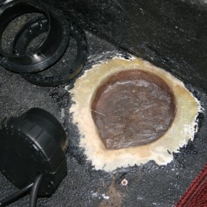 carved out with a hole saw and finished with a vibratory power tool with sanding disc and rasp - also shown is the coat of glass and resin to seal it up.