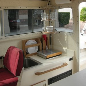 Galley with corner shower caddy, plate holder and paper towel holder and towel rod/handhold