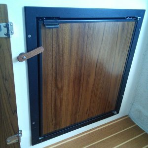 Dometic Tundra refrigerator.   Front door comes off and door panel can easily be removed to work on.  Varnished veneer panel has been slid in front of original plastic cover.