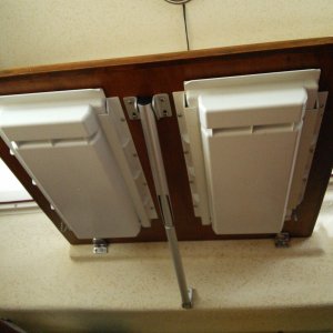 Media 'Underside of drop-down table.   A slide out plastic drawer has been installed on each side of the support bracket.  A small thru-bolt is inserted in the track and drawer towards the back of each drawer when not in use to keep it from opening and spilling the contents when underway or while trailering.' in album 'New Drawers... each piece was modular and we actually ended up placing deeper drawers on the top parts of a less deep rack (to fit along the angle of the hull).     Note:  we have now been using these for ~7 years and still love them.   They still look and work like new with absolutely no signs for wear or rust.'